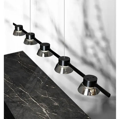 Modern decorbites black strip chandelier featuring five sleek black and chrome cylindrical bulbs suspended by thin cords