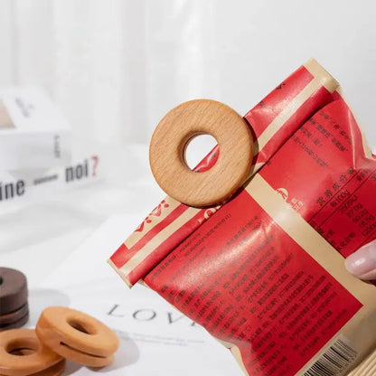 Light brown wooden bag clip in a donut shape made of decorbites black walnut for kitchen sealing use