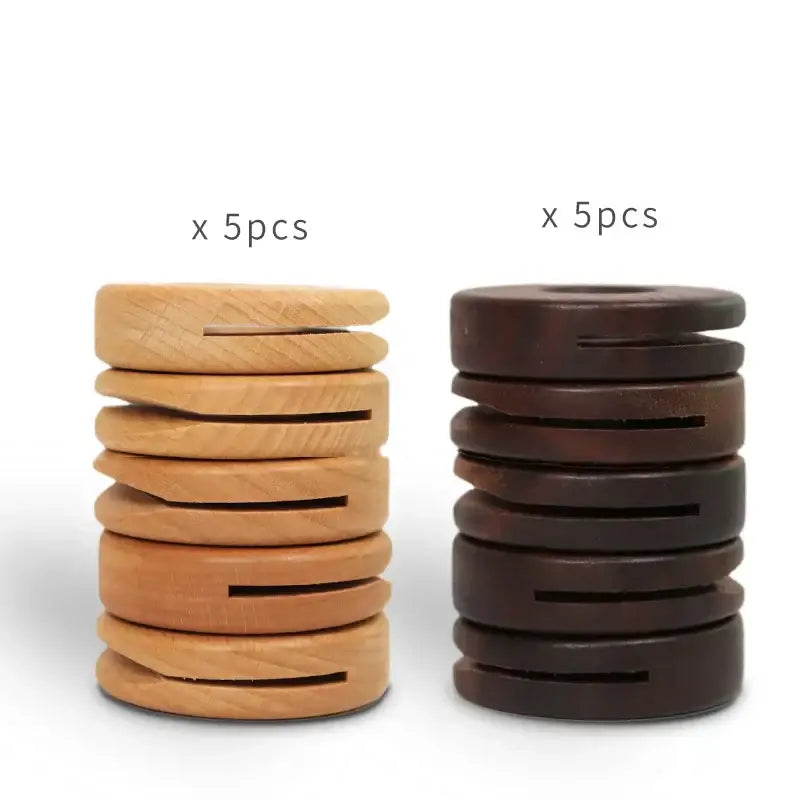 Two stacks of decorbites black walnut donuts bag clips in natural light and dark brown wood for kitchen sealing
