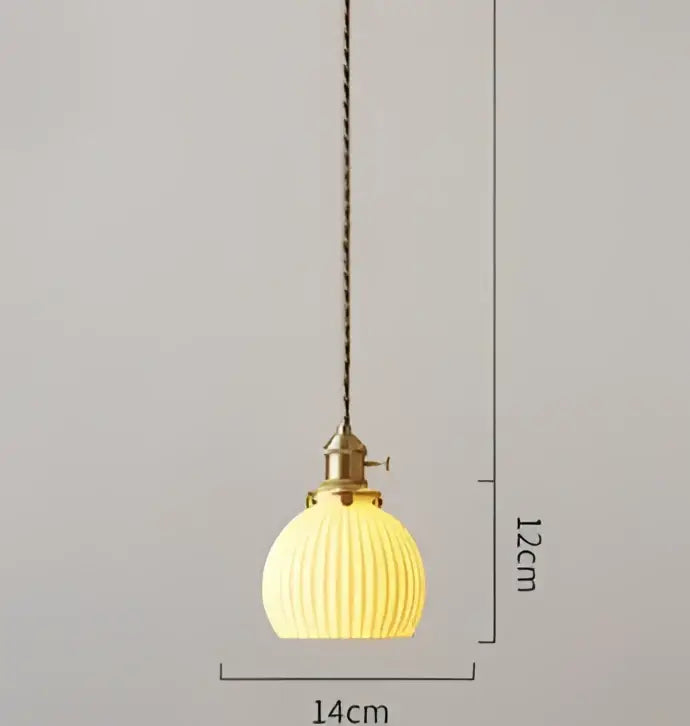 A warm yellow ribbed glass pendant light with brass fixture and chain, complementing decorbites blue glass pendant style