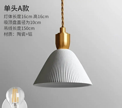 White ribbed ceramic pendant light with gold-toned fixture and twisted cord complementing decorbites blue glass pendant light