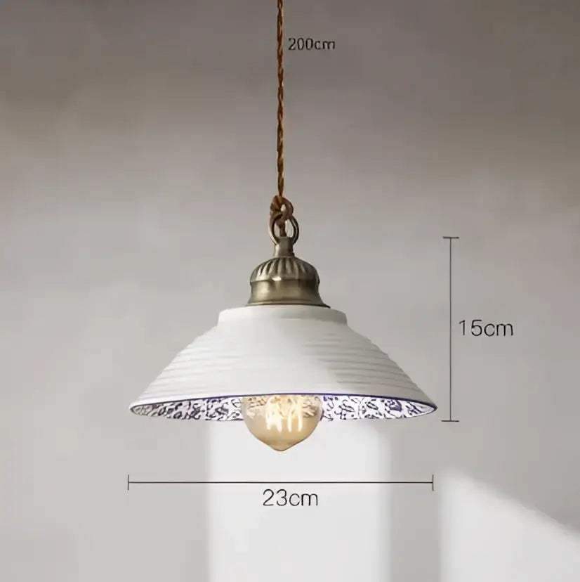 White ceramic pendant light with blue floral rim and antique brass fixture for dining room featuring decorbites blue glass pendant lights
