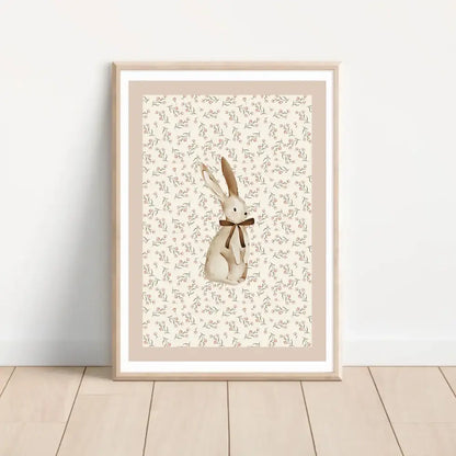 A framed beige rabbit illustration with a brown bow on floral background in decorbites bohemian style wall art set