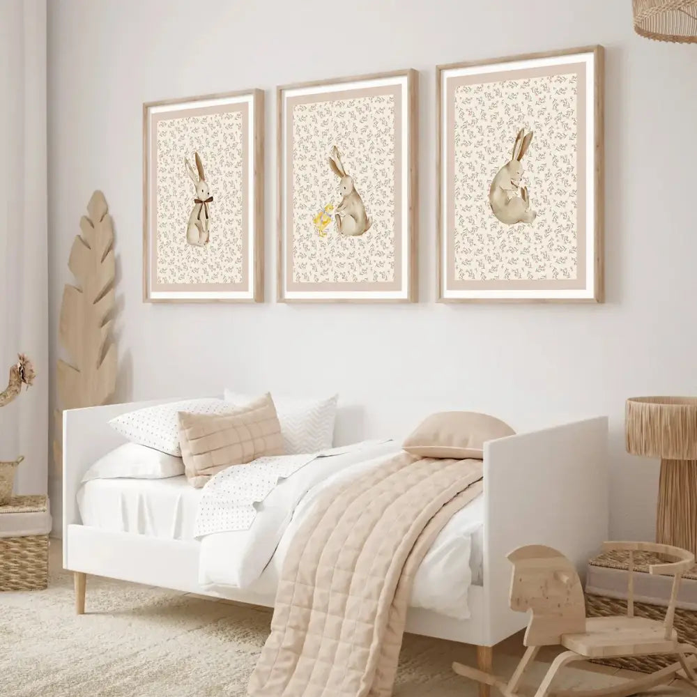 Three framed beige rabbit prints in light wood frames featuring delicate floral backgrounds bohemian style wall art set