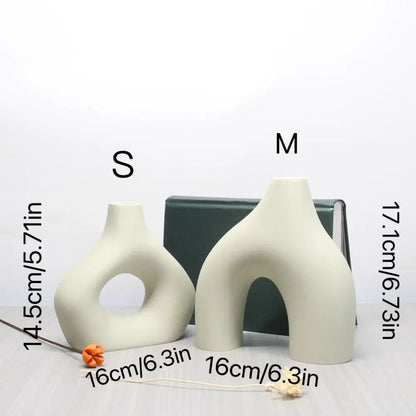 Cream-colored ceramic vase set with abstract organic shapes and central archway for bohemian home decor by decorbites