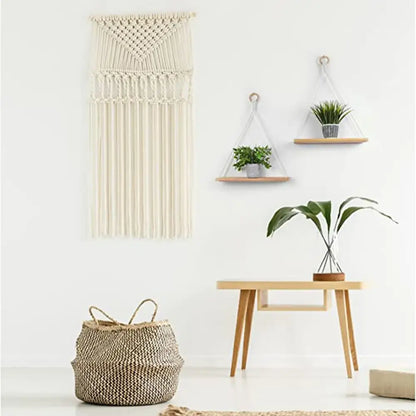 Cream-colored decorbites™ boho macrame hanging shelf with triangular top and long fringe for wall decor