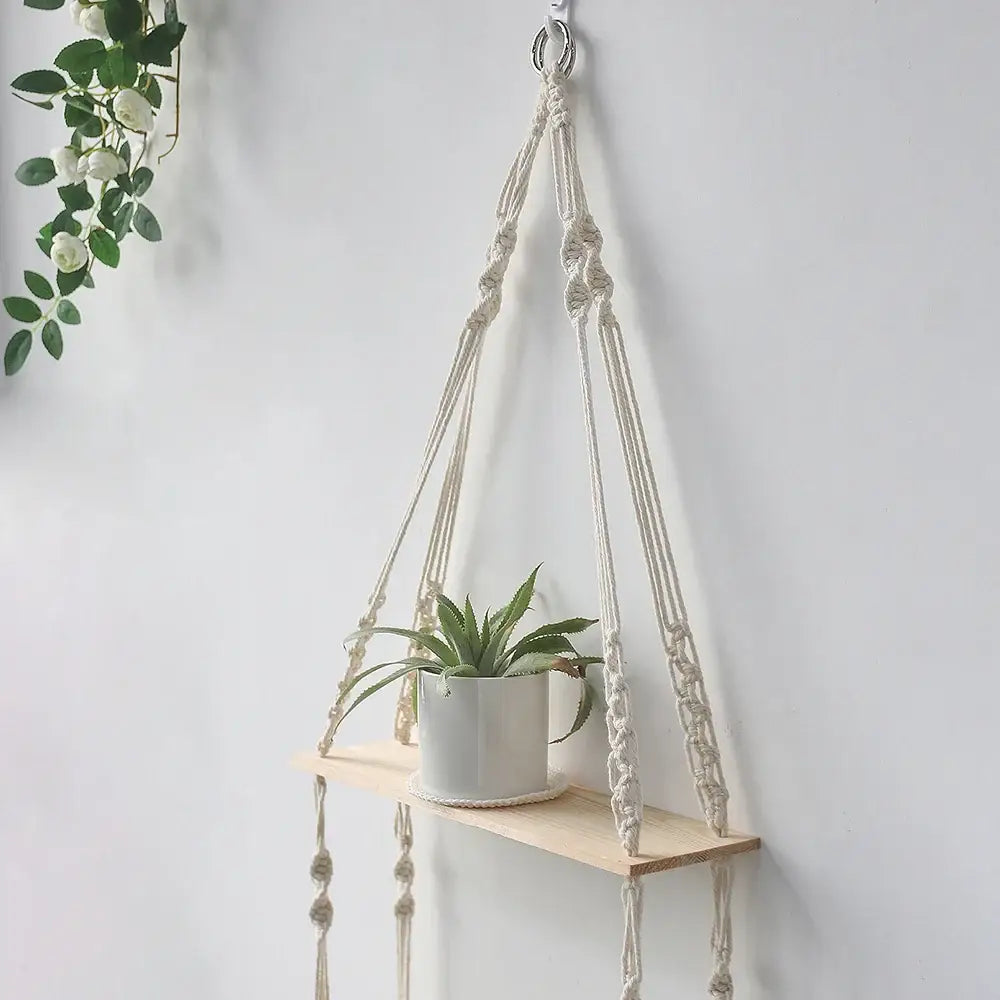 DecorBites™ boho macrame wall shelf with light wood plank and cream cords holding green succulent for home decor
