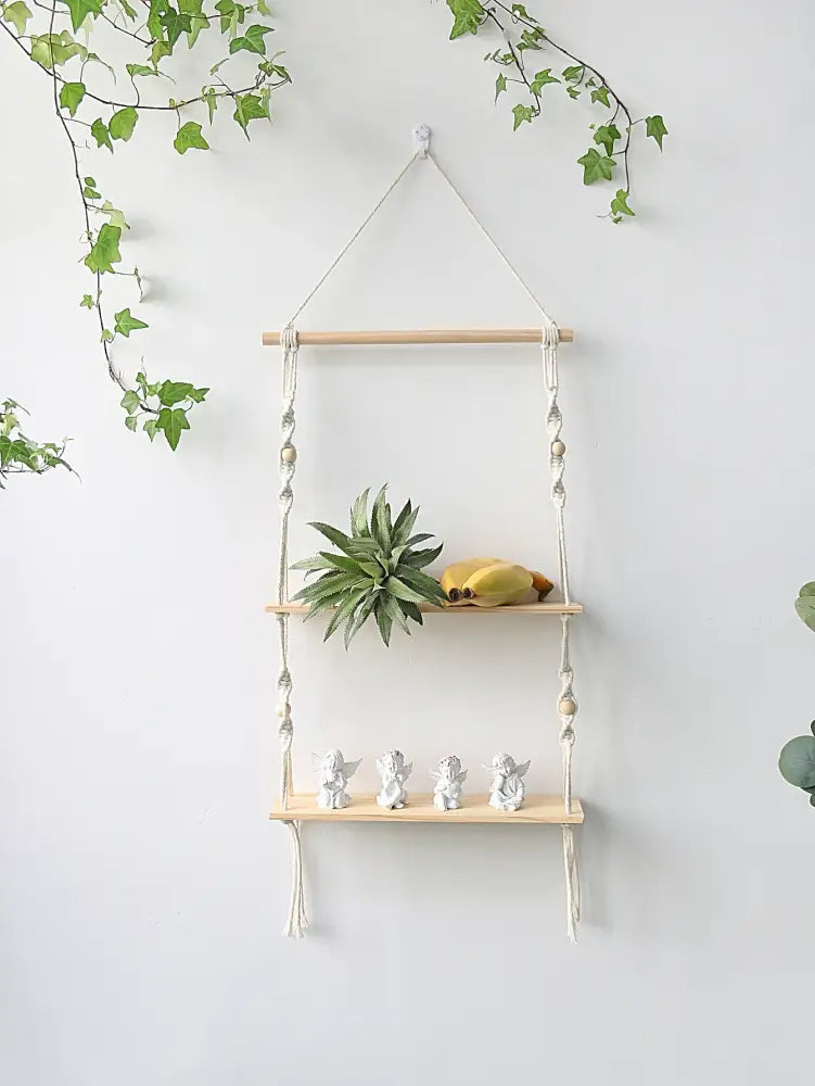 DecorBites™ boho macrame wall shelf with light wood slats and white angel figurines for home decor