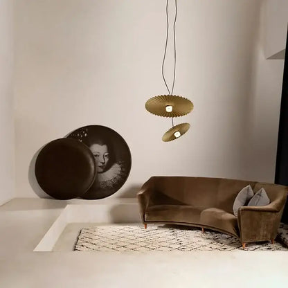 Gold-toned fan-shaped pendant lights with modern design complement decorbites boomerang wood black and cream pleated fan lamp