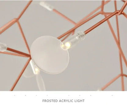 Frosted acrylic light with warm glow suspended from copper-toned rods in decorbites branch design rose gold black chandelier