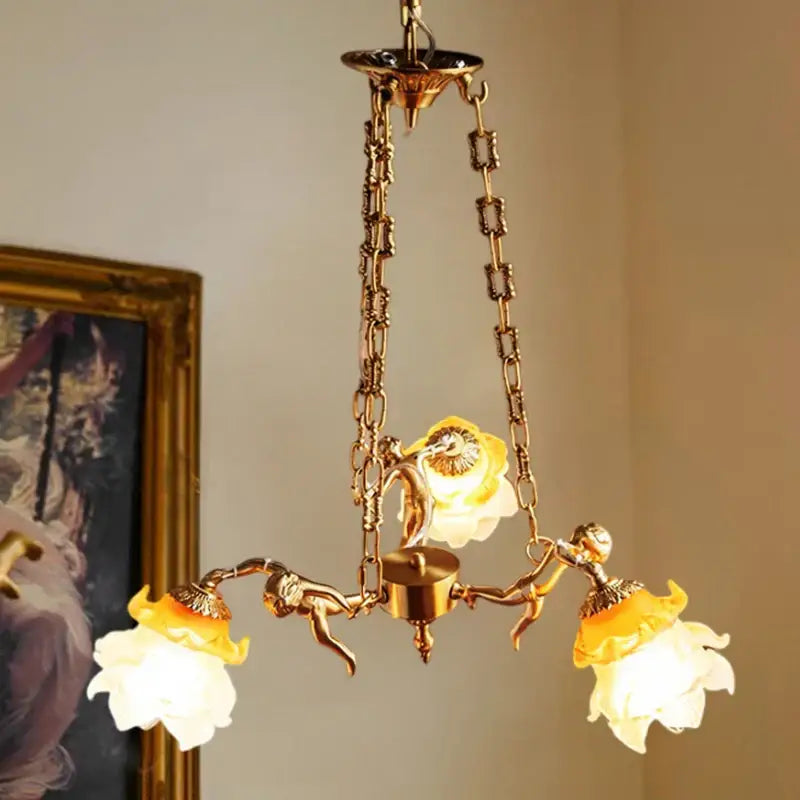 Golden decorbites brass angel chandelier with ornate chains and three flower-shaped glass shades for living room decor
