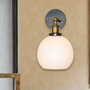 Industrial brass wall sconce with bubble white glass globe and brass fixture for bedroom lighting