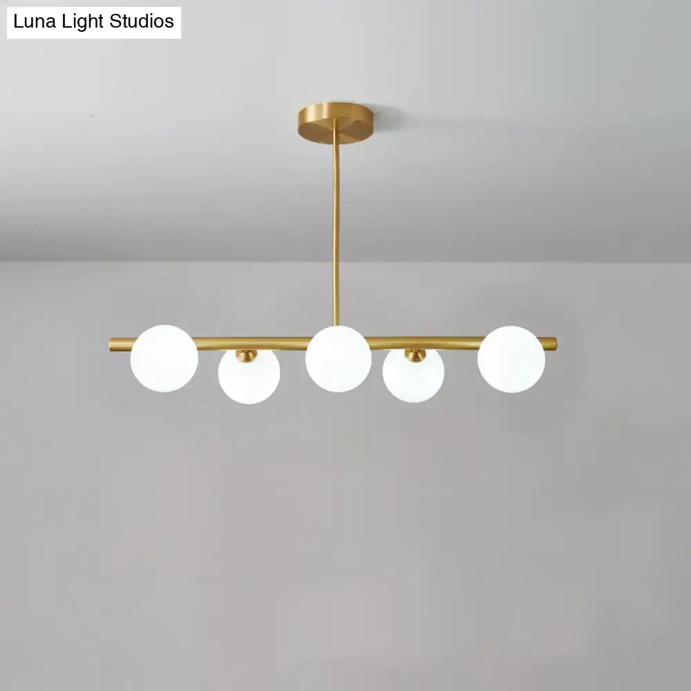 DecorBites brass island pendant light fixture with five frosted glass globes for dining room ceiling light