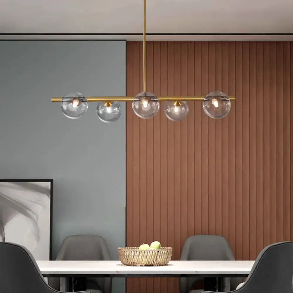 Modern brass ceiling light with five clear glass globe shades for dining room glass dining room lighting fixture