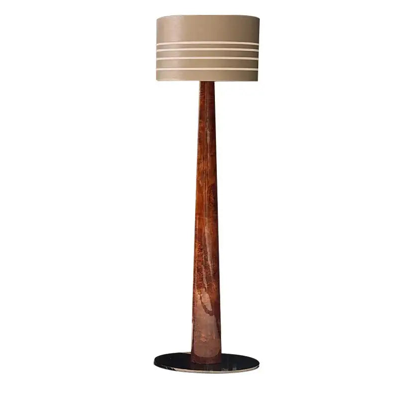 Tall floor lamp with slender textured copper base and beige drum shade in decorbites brown leather wooden style