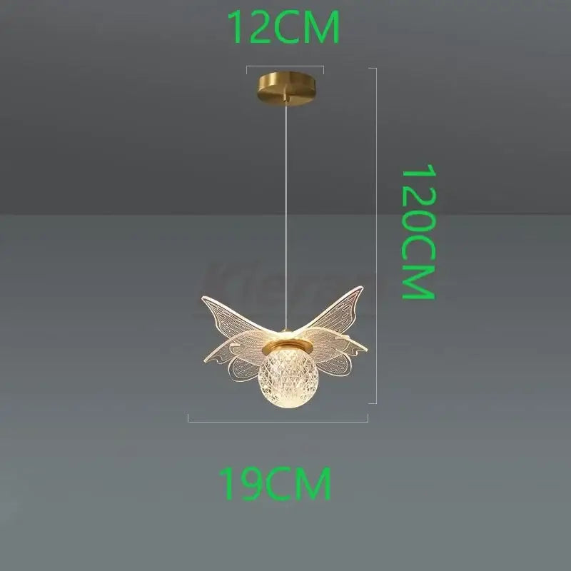 A delicate gold-toned decorbites butterfly led pendant light with intricate wirework wings and frosted glass globe