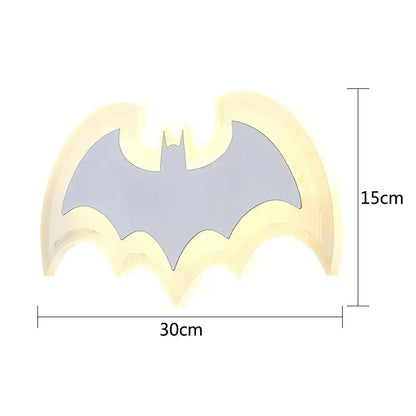 A glowing yellow and gray decorbites cartoon bat wall lamp made of warm yellow acrylic for bedroom lighting