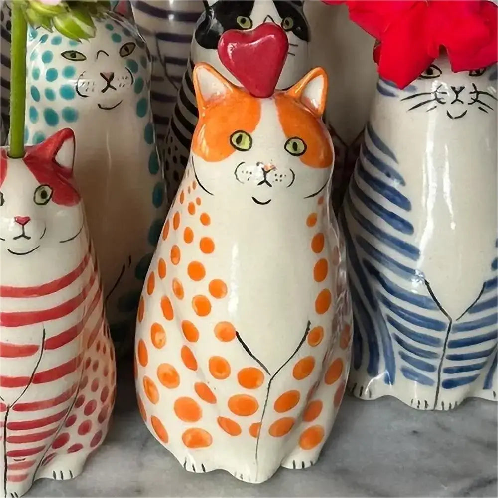 DecorBites™ cat polka dot resin flower bud vase with white base, orange dots, yellow eyes, and red heart top