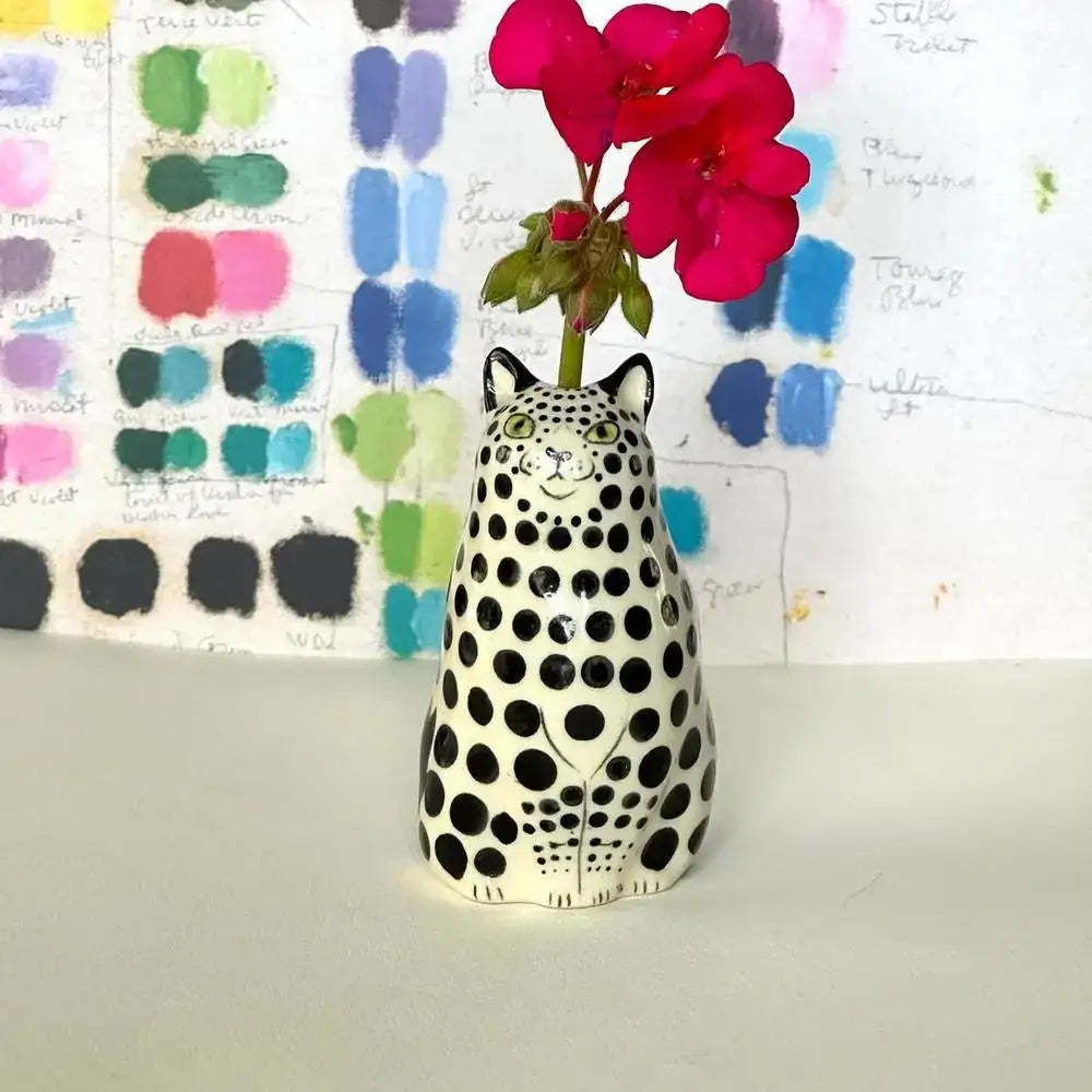 DecorBites™ cat polka dot resin flower bud vase shaped like a white spotted dot cat holding bright pink flowers