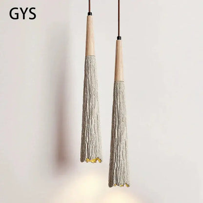 Two gys brand decorbites cement cream led pendant lights with wooden tops and grayish beige tassel bodies for bedside use