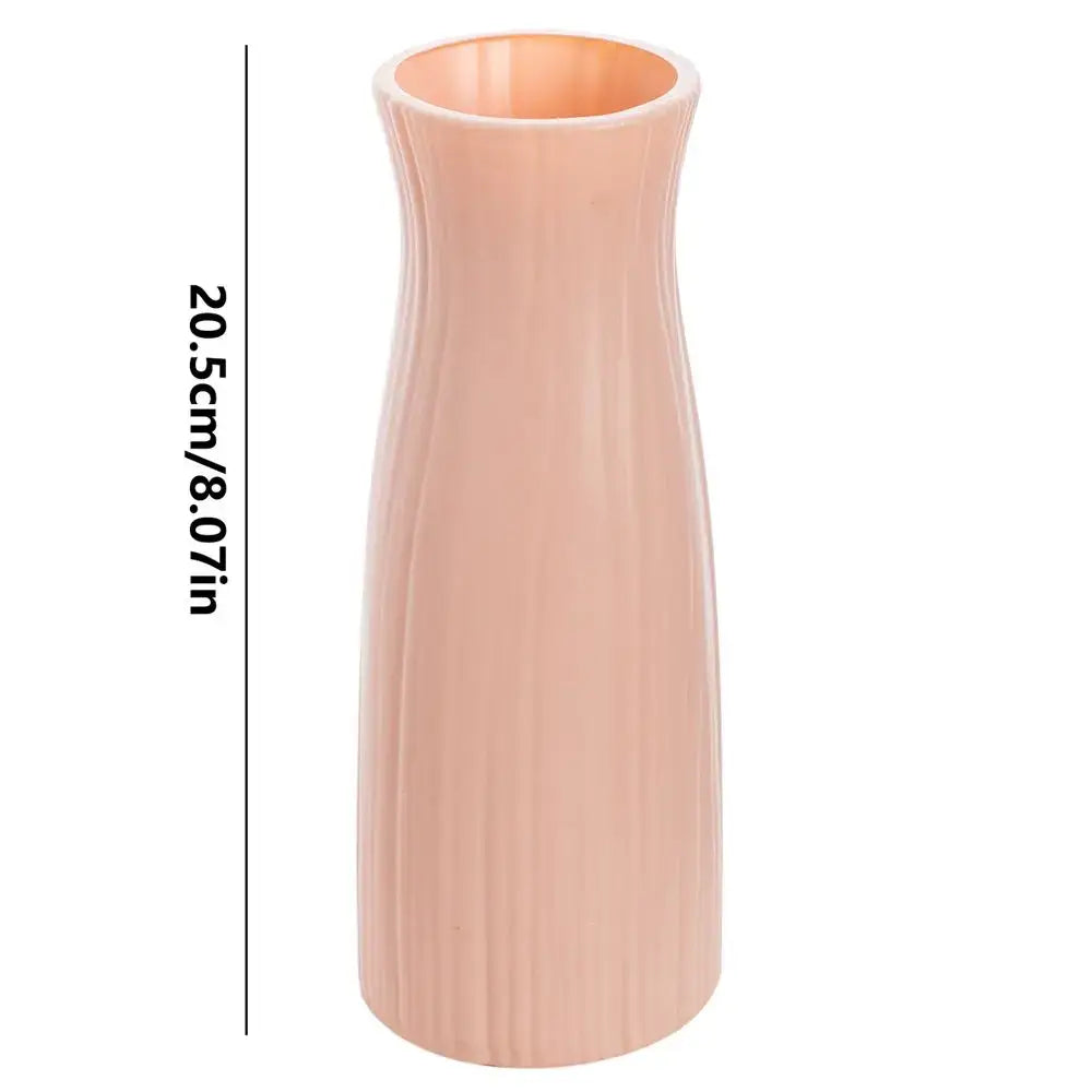 A sleek peach-colored plastic vase imitation with vertical ribbed texture and flared opening from decorbites ceramic-look plastic flower pots