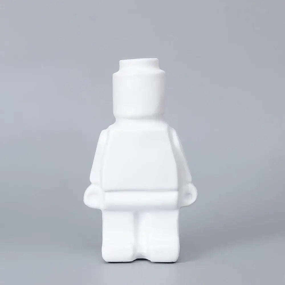 White ceramic robot vase shaped like a lego minifigure for nordic style home decor by DecorBites