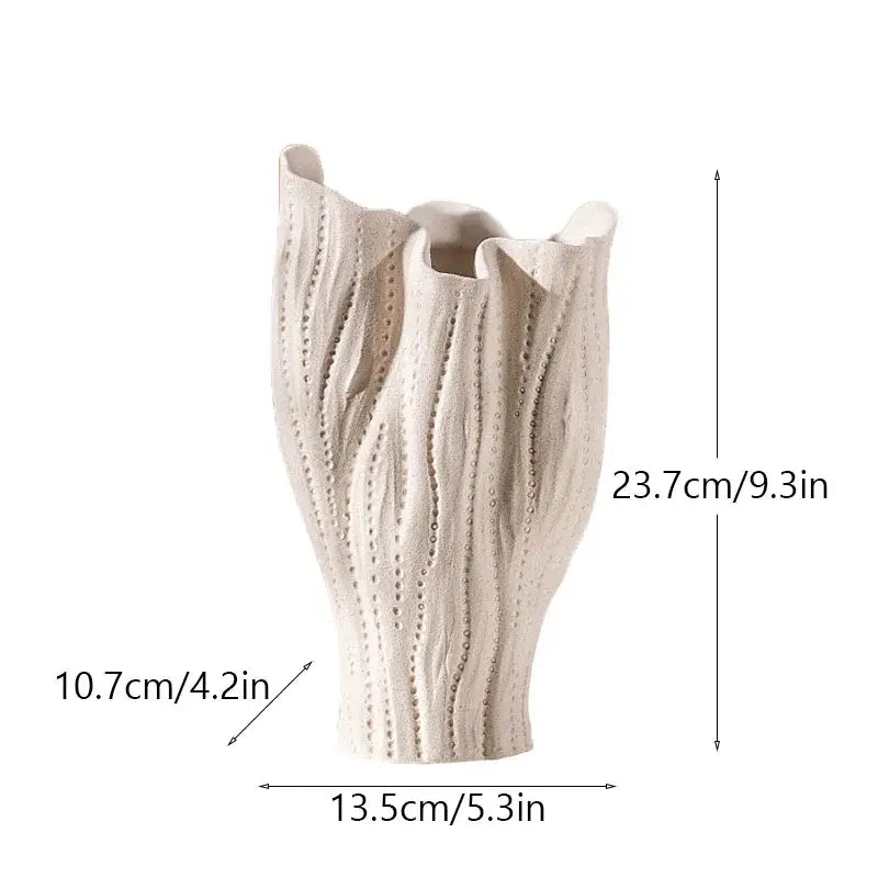 Cream-colored ceramic sea vase with textured ribbed sides and flared top for nordic modern decor by DecorBites