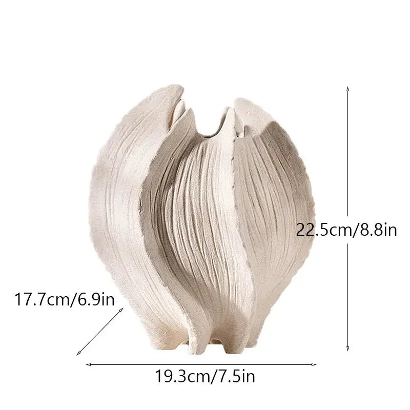 Cream-colored ceramic sea vase with textured sculpted leaf design embodying nordic modern decor style by DecorBites