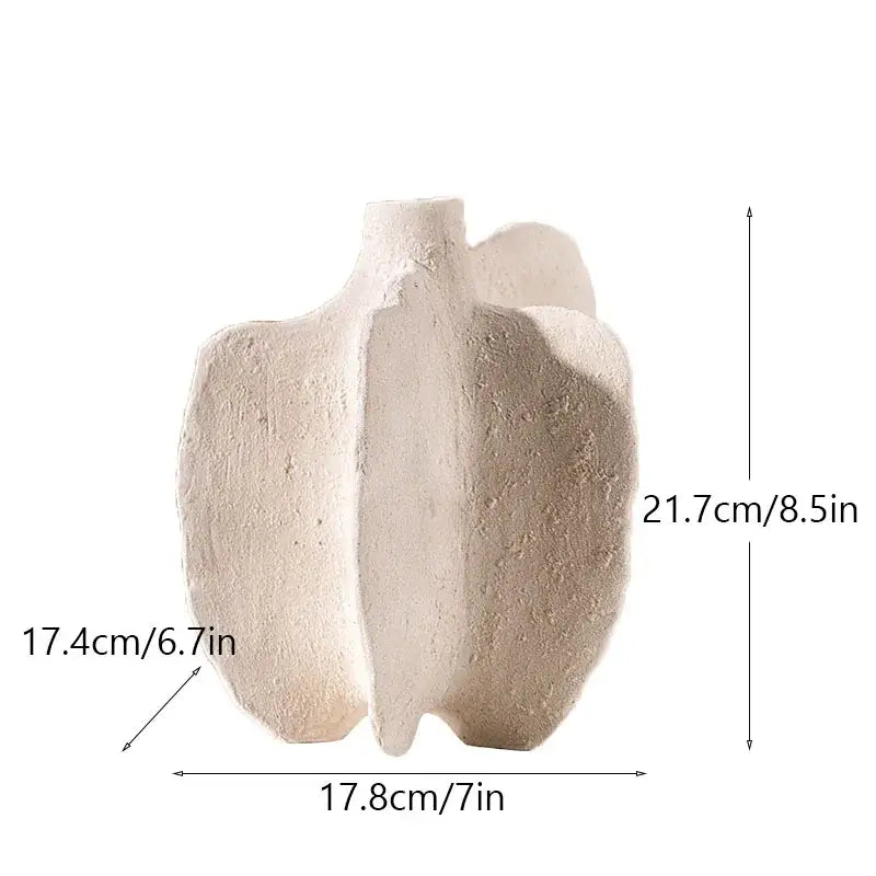 Cream-colored ceramic sea vase with textured surface and asymmetrical nordic modern design by decorbites