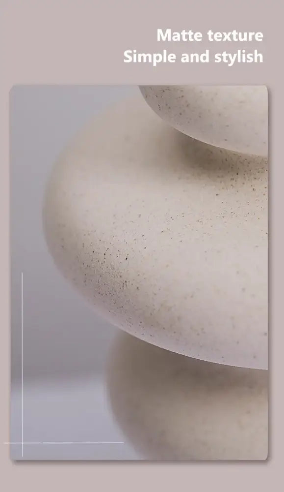 Cream-colored matte-finished ceramic vases with subtle speckled texture for modern home decor by decorbites