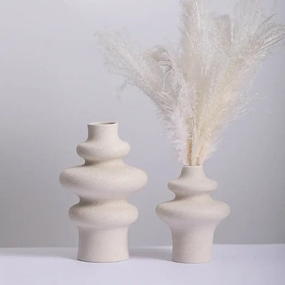 Cream-colored ceramic vases with a textured speckled finish and stacked rounded tiers for modern home decor by decorbites