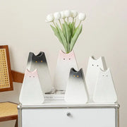 A set of five ceramic cat ceramic vases in gradient white and gray with black eyes for living room decor holding white tulips