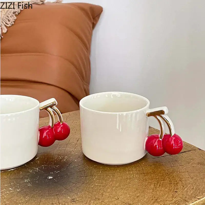 White ceramic DecorBites cherry handle mug with glossy red cherry handle and gold-tone metal for tea and coffee cups