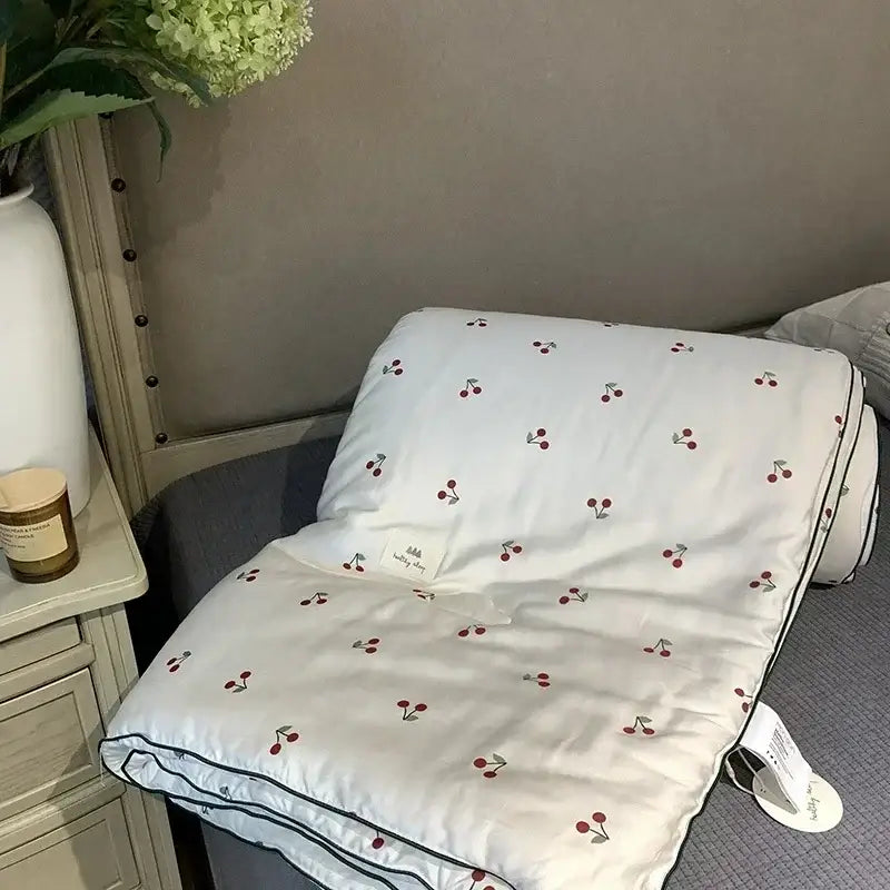 White quilt with red cherry embroidery and black piping edges in decorbites cherry lyocell fiber cooling blanket