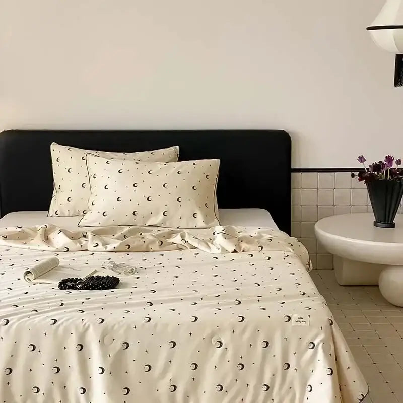 Cream-colored decorbites cherry lyocell fiber cooling blanket with black crescent moons and stars for child adults