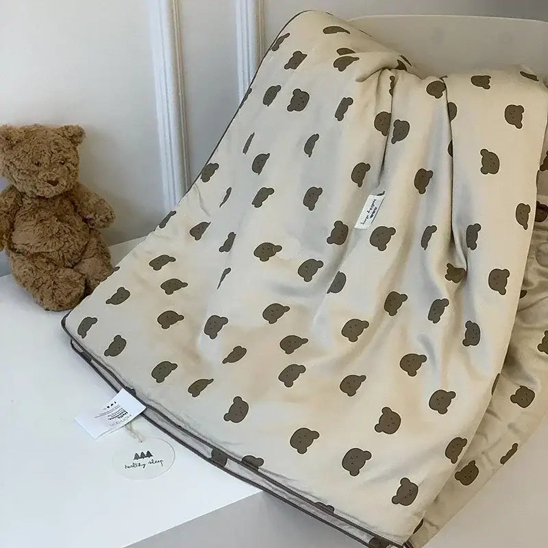 Cream-colored decorbites cherry lyocell fiber cooling blanket with brown teddy bear pattern and soft finished edges