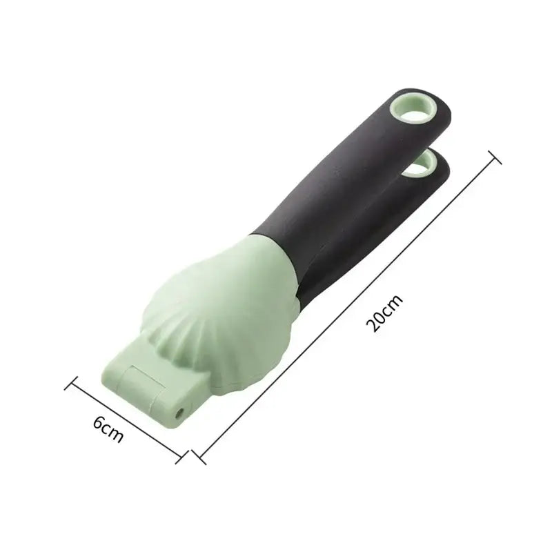 A two-toned silicone nut cracker with matte black handle and light green pressing head in decorbites chestnut machine set