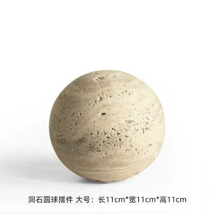Beige concrete sphere decorative ornament with a textured porous surface featuring subtle natural imperfections for wabi sabi wind decor