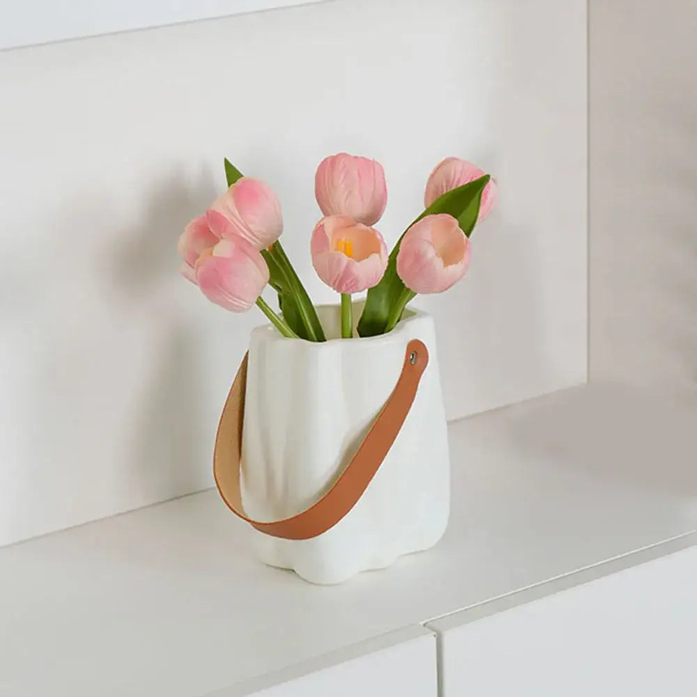 White ceramic vase with tan leather handle holding pink tulips decorbites chic ceramic vase for home decoration
