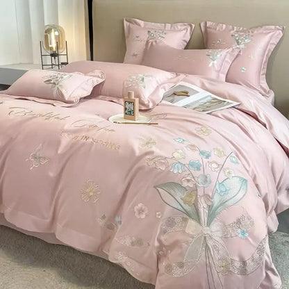 Pink satin bedding set with delicate floral embroidery and bow design from decorbites chic flowers embroidery collection