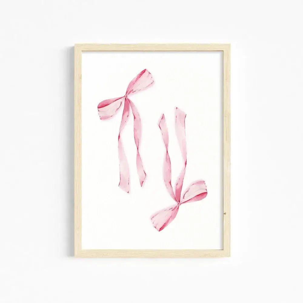 DecorBites™ chic pink wall art featuring a delicate watercolor print of pink ribbons in a light wood frame for girls room