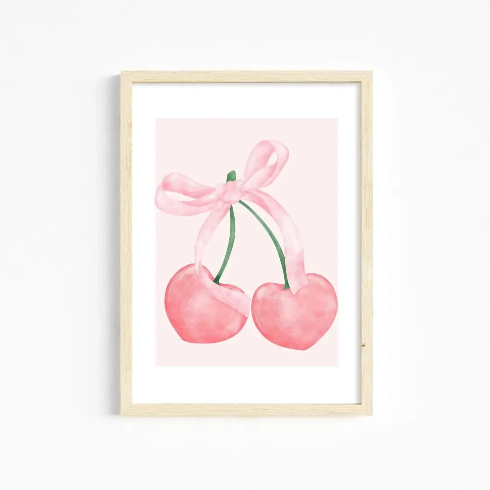A framed watercolor print of two pink heart-shaped cherries tied with a ribbon bow for girls room pink wall art