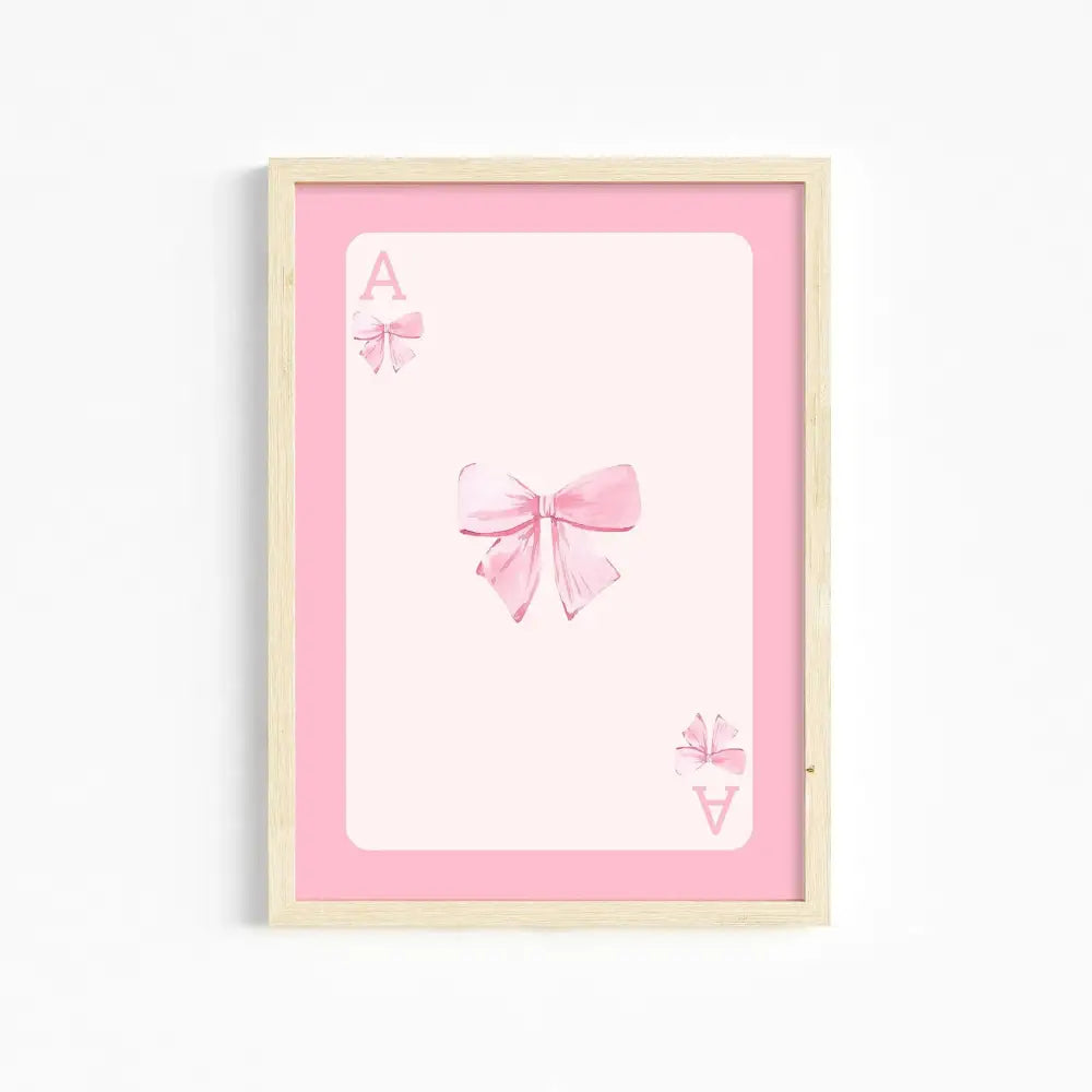 A framed pink and white ace card illustration with delicate bows pink wall art for girls room by DecorBites™