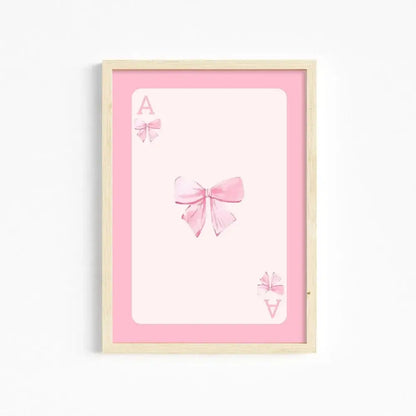 A framed pink wall art print by decorbites featuring a watercolor bow design for girls wall decor