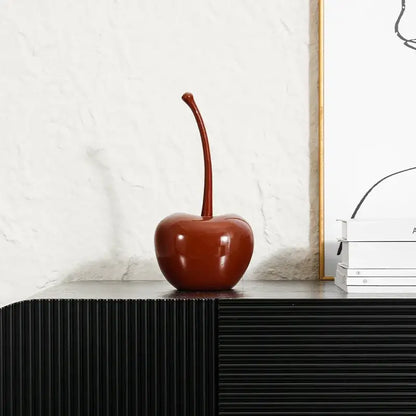 A glossy deep red cherry resin ornament with a long stem from decorbites chic red chic red cherries collection