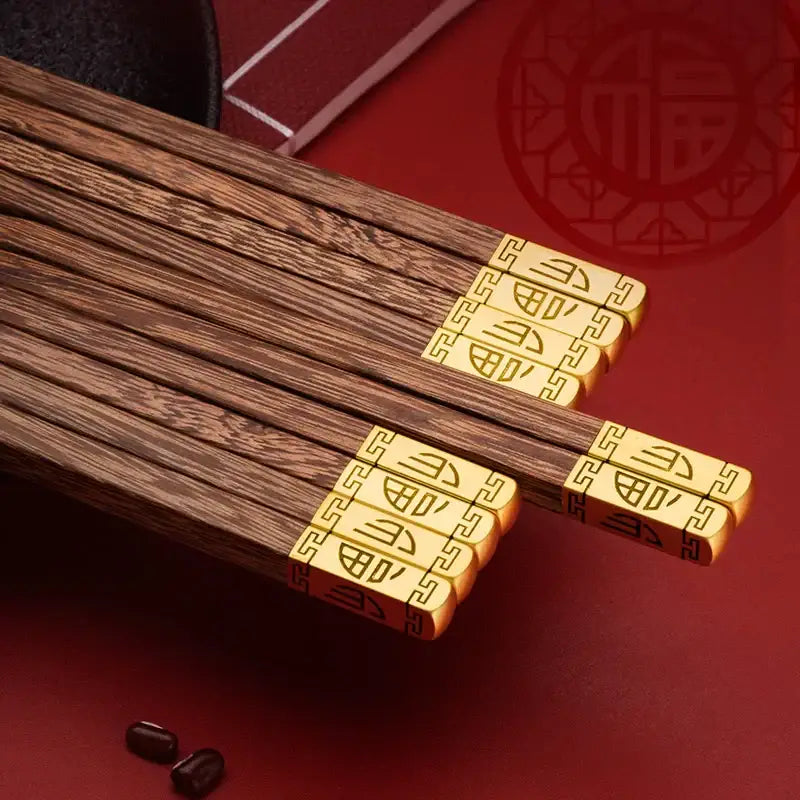 DecorBites™ chicken-wing wood chopsticks set with dark wood and golden engraved ends featuring chinese characters
