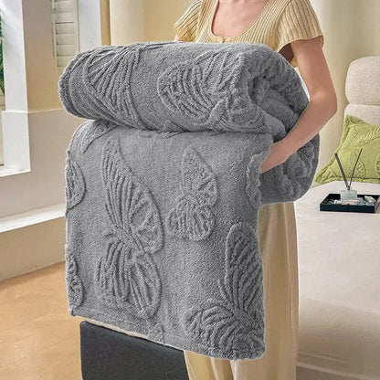 A plush medium-gray decorbites chiffon butterfly jacquard throw blanket with raised butterfly and leaf patterns in soft fabric