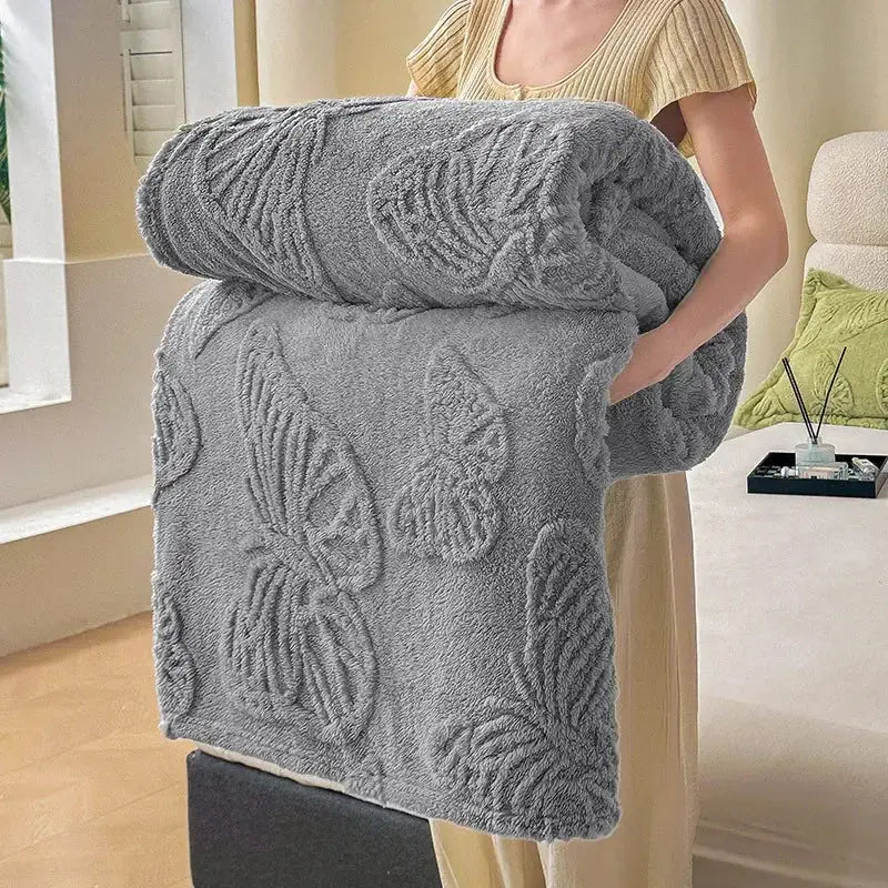A plush medium-gray decorbites chiffon butterfly jacquard throw blanket with raised butterfly and leaf patterns in soft fabric