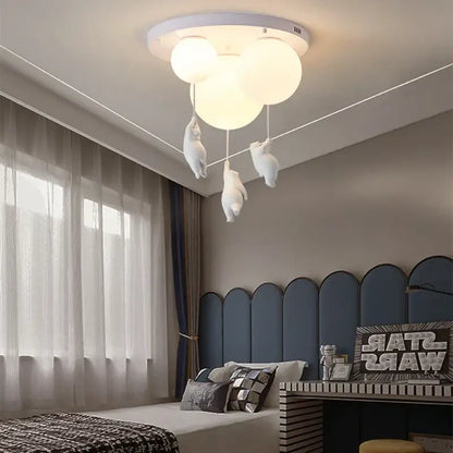 White ceiling chandelier featuring three spherical LED bulbs and dangling plush bear astronaut figures for decorbites children nordic decor