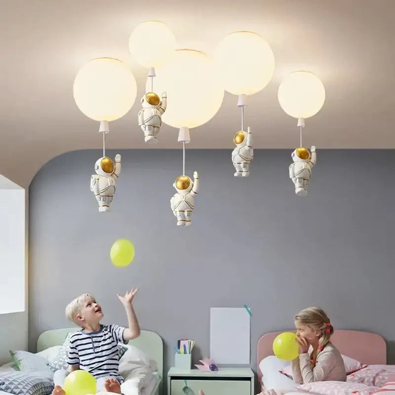 Decorbites children nordic bear astronaut ceiling chandelier with white fixture, golden helmets, and balloon-like bulbs